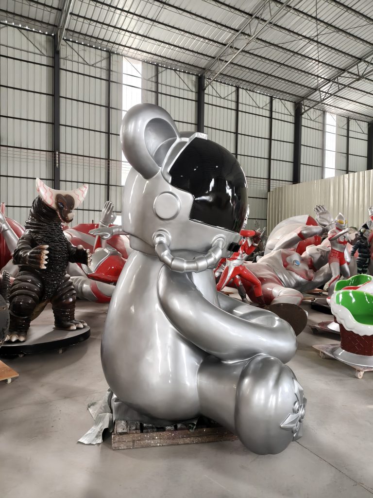 Close-up of metallic astronaut bear fiberglass sculpture with glossy silver finish