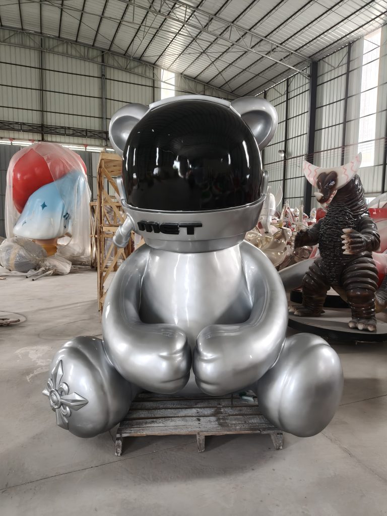 Silver space bear fiberglass sculpture with astronaut helmet in factory showroom