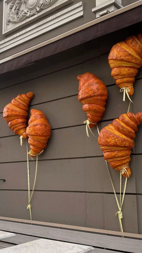 Croissant wall sculpture installation bakery interior design