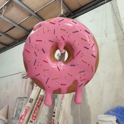 Pink donut sculpture display in retail space