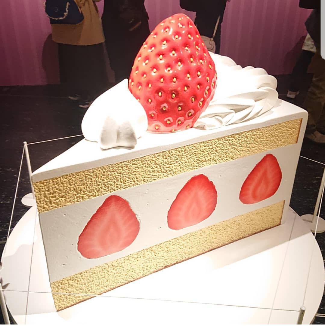 Strawberry cake sculpture display in mall interior
