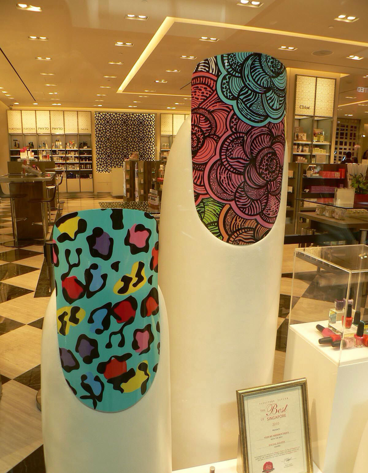 Tolili custom fiberglass giant finger sculptures displaying colorful nail art in a luxury salon