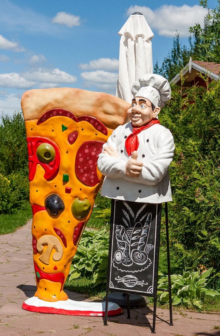 giant pizza slice and chef statue sculpture